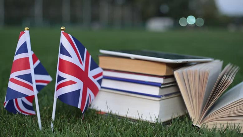 A flag next to a stack of booksAI-generated content may be incorrect.
